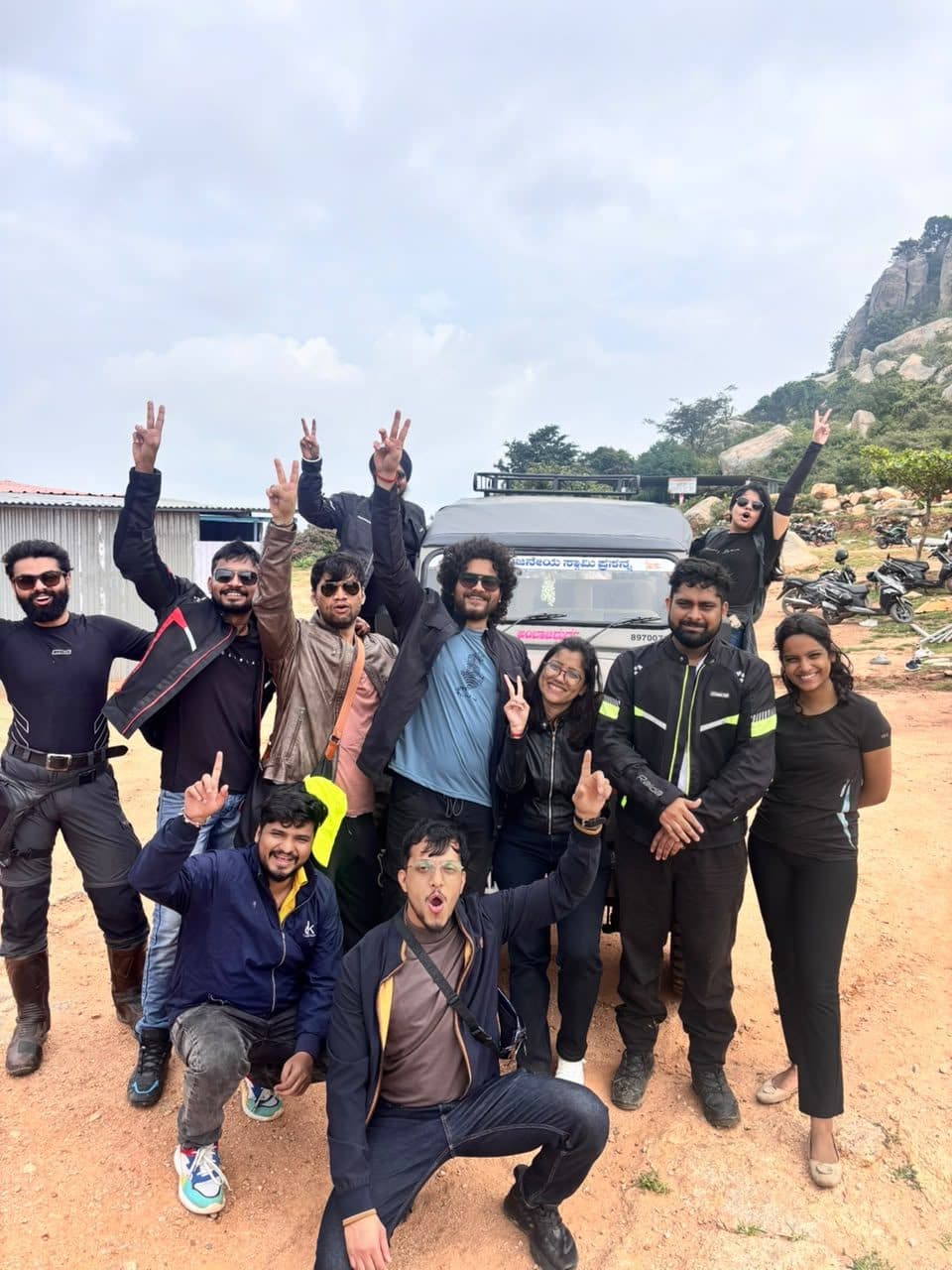 Riders and the Tempo Traveller group together at the same stop